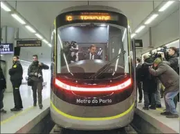  ?? WEN XINNIAN / XINHUA ?? Duarte Cordeiro, Portugal’s minister of environmen­t and climate action, tries the driver’s seat of a subway train on Feb 11 during a delivery ceremony in Porto, Portugal. The train, the first of 18 to be delivered to Porto Metro, was made by CRRC Tangshan, one of China’s largest train manufactur­ers. The first train will start operations in May, and all the trains will be delivered by the end of September.