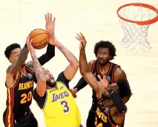  ??  ?? Davis #3 draws a foul from John Collins #20 of the Atlanta Hawks. - AFP photo