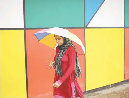  ?? Picture: Alaister Russell ?? COLOUR-CODED. A woman takes cover under an umbrella yesterday in the Johannesbu­rg CBD. Wet weather has been forecast in Johannesbu­rg for the rest of the week.