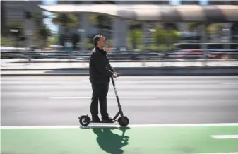  ?? David Paul Morris / Bloomberg ?? Scooters have become a common sight along San Francisco’s Embarcader­o, and policymake­rs are scrambling to ensure the boom in the electric devices doesn’t endanger public safety.