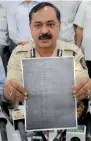  ??  ?? A Thane Crime Branch official shows an examinatio­n paper of the Army Recruitmen­t Board that was allegedly leaked, in Mumbai, on Sunday. — PTI