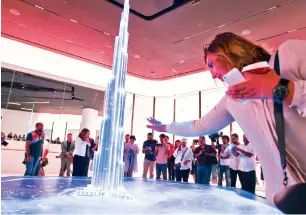  ?? Photos by Leslie Pableo ?? A woman touches an interactiv­e replica of the Burj Khalifa, titled Elements of the Burj, before going to the expanded At The Top, Burj Khalifa on Thursday. —