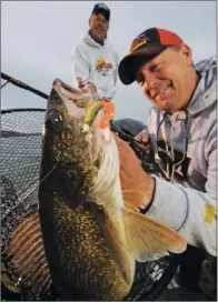  ?? COURTESY OF FRABILL ?? Top: Greers Ferry Lake has the potential for producing another 27-pound-plus world-record hybrid striper, but anglers are most likely to catch hybrids in the 5- to 15-pound class. Above: Greers Ferry Lake world-renowned walleye fishing is best during...