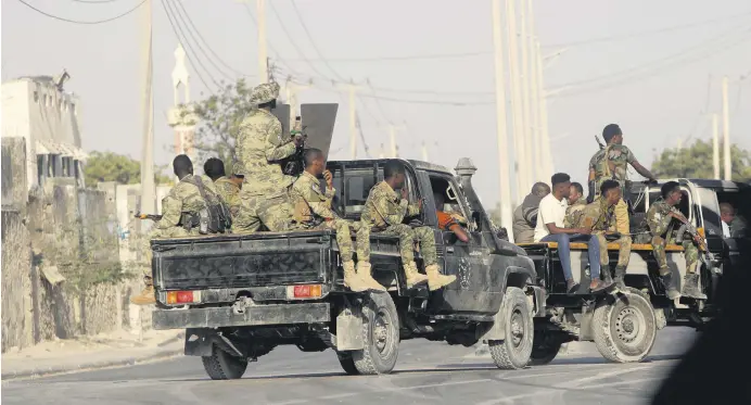  ?? ?? Security patrol the streets during fighting between al-Shabab extremists and soldiers in Mogadishu, Somalia, Feb. 21, 2023.