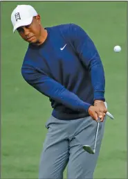  ?? Associated Press ?? Practice: Tiger Woods chips to the second green during a practice round for the Masters golf tournament earlier this week in Augusta, Ga.