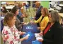  ?? SUBMITTED PHOTO ?? Pictured, right, background to foreground: Chester County Commission­ers Terence Farrell, Michelle Kichline and Kathi Cozzone meet with county residents to hand out doses of Naloxone at the Chester County Library, during Naloxone Giveaway Day.