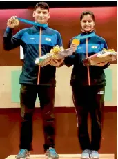  ?? — PTI ?? Om Prakash Mitharval and Manu Bhaker pose with their medals after winning the 10m air pistol mixed team gold at the ISSF World Cup in Guadalajar­a, Mexico, on Tuesday.