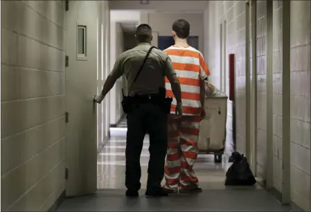  ?? AP PHOTO ?? In this Feb. 21, 2013 file photo, an inmate at the Madera County Jail is taken to a housing unit at the facility in Madera.