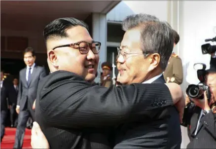  ?? THE ASSOCIATED PRESS ?? This South Korean government handout shows North Korean leader Kim Jong Un, left, and South Korean President Moon Jae-in embracing Saturday after their meeting at the northern side of the Demilitari­zed Zone in North Korea.