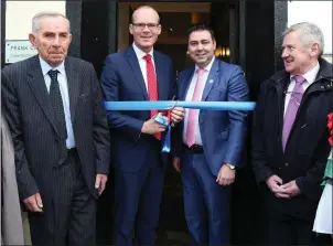 ??  ?? An Tánaiste Simon Coveney cutting the ribbon and officially opening Councillor John Paul O’ Shea’s Office at Strand St., Kanturk, with former TD Frank Crowley and Councillor Gerard Murphy. Photos by Sheila Fitzgerald.