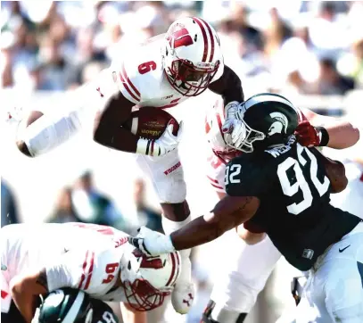  ??  ?? Running back Corey Clement scored two touchdowns to lead the Badgers to a huge road victory in the Big Ten opener. | GETTY IMAGES