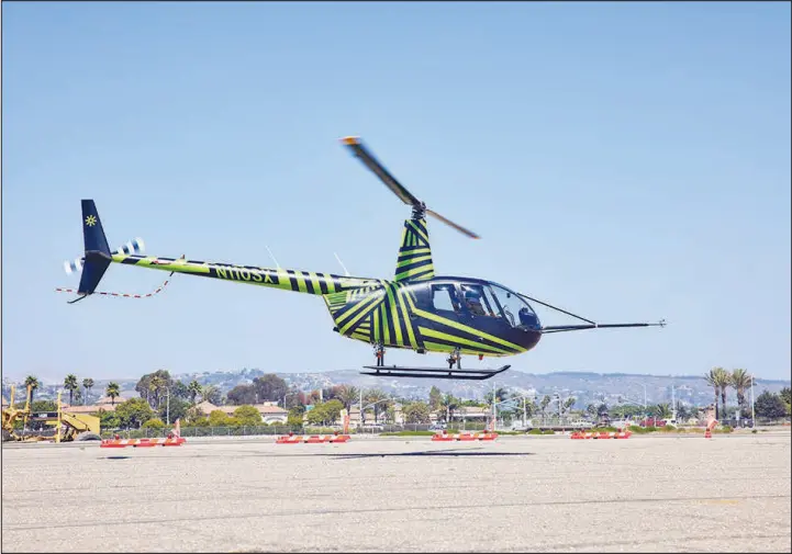  ?? PHOTOS BY RYAN YOUNG / THE NEW YORK TIMES ?? A helicopter is in flight during a Sept. 15 demonstrat­ion of Skyryse’s Flightos system in Camarillo, Calif. Flightos is meant to simplify and automate the operation of passenger aircraft.