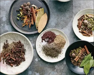  ?? DAVID MALOSH / THE NEW YORK TIMES ?? Clockwise from left: five spice, garam masala, sweet baking spice, baharat and za’atar in New York. Grind these five versatile, beloved mixes ahead of time, then keep them on hand for cooking that’s full of verve and depth.