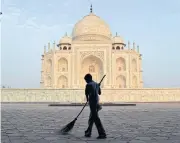  ?? AP ?? A worker sweeps in front of the Taj Mahal in Agra, India. India’s Supreme Court has ordered a state government to remove a crematoriu­m from near the monument to protect it from pollution damage.