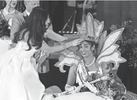  ?? PHOTOS BY SAM UPSHAW JR./COURIER JOURNAL ?? Ankita Nair, right, was crowned as the new Kentucky Derby Festival Queen by former queen Mahshad Taheri during the coronation at the Fillies Derby Ball at the Galt House in Louisville on Saturday.