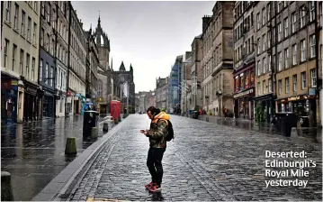  ??  ?? Deserted: Edinburgh’s Royal Mile yesterday