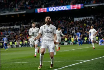  ??  ?? Real Madrid’s Karim Benzema celebrates his goal during a La Liga soccer match between Real Madrid and Deportivo Alaves at the Bernabeu stadium in Madrid, Spain, on Sunday. AP Photo/AnDreA ComAs