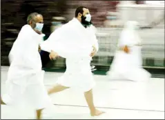  ?? (AP) ?? Muslim pilgrims run at a special part between the two hills of Al-Safa and Al-Marwah, to commemorat­e Lady Hagar’s search for water for her son and herself, at the Grand Mosque, a day before the annual Hajj pilgrimage, July 17.