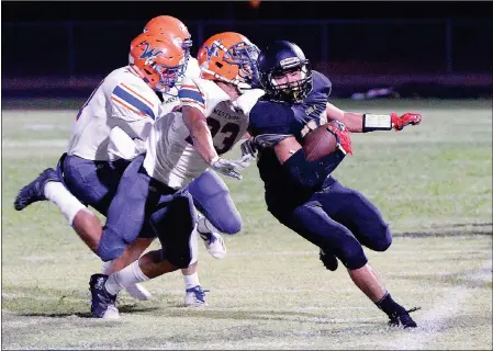  ?? Buy these photos at YumaSun.com PHOTOS BY RANDY HOEFT/YUMA SUN ?? CIBOLA’S ZEKE RIOS (RIGHT) walks the tight rope along the home sideline, picking up yardage for the Raiders while Mesa-Westwood’s Joshua McClintock (23), Keith Whiting (left) and Josh Warren try to make the stop during the first quarter of Friday night’s game at Raider Field.