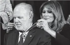  ?? Getty Images file photo ?? First lady Melania Trump places the Presidenti­al Medal of Freedom on radio personalit­y Rush Limbaugh last week.