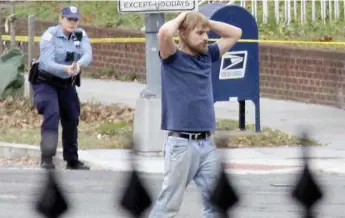  ?? SATHI SOMA VIA THE ASSOCIATED PRESS ?? Edgar Maddison Welch surrenders to police in Washington after dischargin­g a gun inside a pizza parlour.