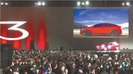  ?? Reuters-Yonhap ?? Tesla introduces one of the first Model 3 cars off the Fremont factory’s production line during an event at the company’s facilities in Fremont, Calif., Friday.