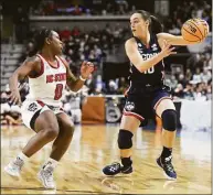  ?? Tyler Sizemore / Hearst Connecticu­t Media ?? UConn’s Nika Muhl, right, dribbles around NC State’s Diamond Johnson in their Elite Eight game March 28.