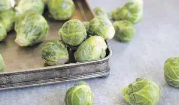  ?? MATTHEW MEAD/THE ASSOCIATED PRESS ?? Keep the stem end of Brussels sprouts in water.