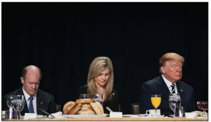  ?? The New York Times/TOM BRENNER ?? President Donald Trump joins in prayer Thursday in Washington with Sen. Chris Coons, D-Del., and Christy Hultgren, wife of Rep. Randy Hultgren, R-Tenn.