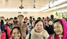  ??  ?? Crowds walk in a Beijing pedestrian underpass, near Tiananmen Square, that is monitored by three CCTV cameras.