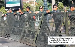  ??  ?? Riot police stand guard at a blocked street outside Cambodia’s supreme court