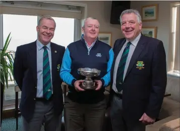  ??  ?? Kevin O’Gorman, captain 2017, and Peter Burgess, captain 2018, present Andy Kavanagh with the Club Championsh­ip trophy at the Blainroe Golf Club AGM 2017.