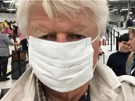  ??  ?? I’m off: Mr Johnson takes selfie in a face mask at airport