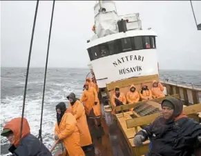  ?? — afp ?? Whale-watchers off the coast of the tiny fishing village of Husavik, Iceland. a study has found that tourist boats disrupt the feeding of minke whales in the short term.