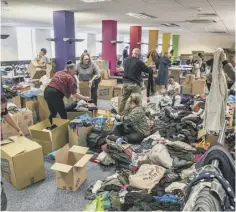  ?? ?? BUSY: Volunteers sorting donations at Dean Clough, Halifax.