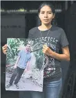  ?? ?? Hernandez, poses with a picture of her husband Jose Dimas Medrano, who was captured during the emergency regime and later died of kidney failure while in prison, speaks during an interview with AFP.