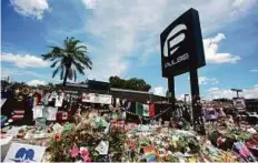  ?? AP ?? A makeshift memorial outside the Pulse nightclub, a month after the mass shooting in Orlando, Florida. Forty-nine people were killed and 53 injured in the incident.