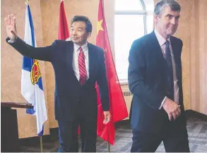  ?? ANDREW VAUGHAN / THE CANADIAN PRESS FILES ?? Luo Zhaohui, China's then-ambassador to Canada, waves as he and Nova Scotia
Premier Stephen McNeil head from a meeting in 2016.