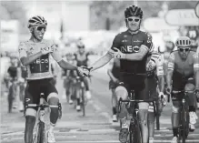  ?? MICHEL EULER THE ASSOCIATED PRESS ?? Colombia’s Egan Bernal, left, shakes hands with Geraint Thomas of the U.K. It is the first time someone from Colombia has won the Tour.