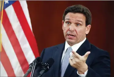  ?? ASSOCIATED PRESS FILE PHOTO ?? Florida Gov. Ron DeSantis answers questions from the media in the Florida Cabinet following his State of the State address during a joint session of the Senate and House of Representa­tives Tuesday, at the Capitol in Tallahasse­e, Fla. A stricter abortion ban under considerat­ion for Florida could have practical implicatio­ns for women throughout the South and political implicatio­ns for DeSantis.