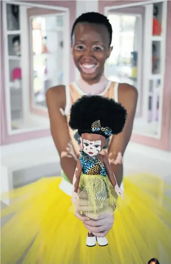  ?? Picture: Alaister Russell ?? Nobuntu Morake, a young woman who has the skin condition vitiligo, holds up Ndanaka, a doll in the Sibahle Collection that was inspired by people with vitiligo.