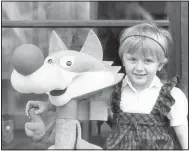  ?? (File Photo/AP/Bob Dear) ?? Amela Dizdar, 3, poses in 1984 with a replica of the Winter Olympics mascot named Vucko in Sarajevo. The mascot was the creation of Joze Trobec, an academic painter from Kranj in Slovenia.