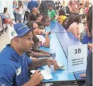  ?? ?? Former Penn State football player and current NASCAR pit crew member Journey Brown signs an autograph for a student at at event in Daytona Beach, Fla.