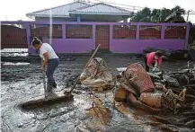  ?? Orlando Sierra / AFP via Getty Images ?? A Honduran woman cleans her house Monday after Hurricane Eta. Tropical Storm Iota now appears to be on the same track.