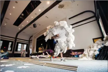  ?? (AP/The Advocate/Leslie Westbrook) ?? Gerald Smith with Bayou Services Moving carries one of many Mardi Gras costume pieces Oct. 12 out of the Central School Arts and Humanities Center, which is home to the Mardi Gras Museum of Imperial Calcasieu, in Lake Charles, La.