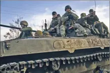  ?? AP photo ?? Ukrainian soldiers ride atop an APC on the frontline in Bakhmut, Donetsk region, Ukraine on Wednesday.