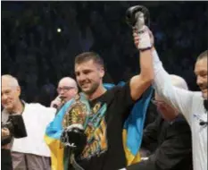  ?? JACQUES BOISSINOT — THE CANADIAN PRESS VIA AP ?? Referee Michael Griffin raises the arm of Oleksandr Gvozdyk, of Ukraine, left, after winning the light heavyweigh­t WBC championsh­ip boxing fight against Adonis Stevenson, of Canada, Saturday in Quebec City.