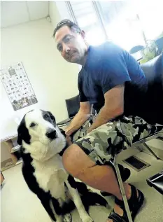  ?? CATHY PELLETIER/ SPECIAL TO POSTMEDIA NEWS ?? Greg Sentance and his dog Buddy visit their Thorold veterinari­an, Dr. Alistair Ker.
