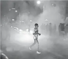  ??  ?? Protesters block the streets after a Trump campaign rally in Albuquerqu­e on Tuesday.