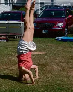  ?? MAUREEN PALERMO ?? The author’s last headstand was captured in a photo by her friend in July 2012 at York Beach in Maine.